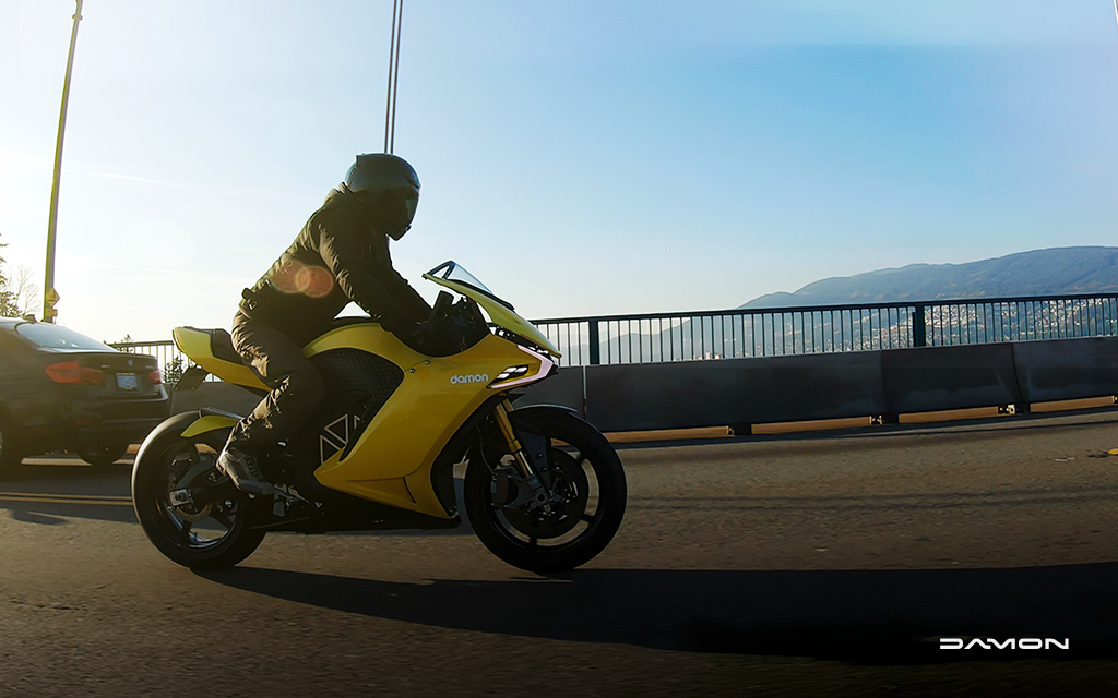 Man riding a gold HyperSport Prototype in a road outside the city