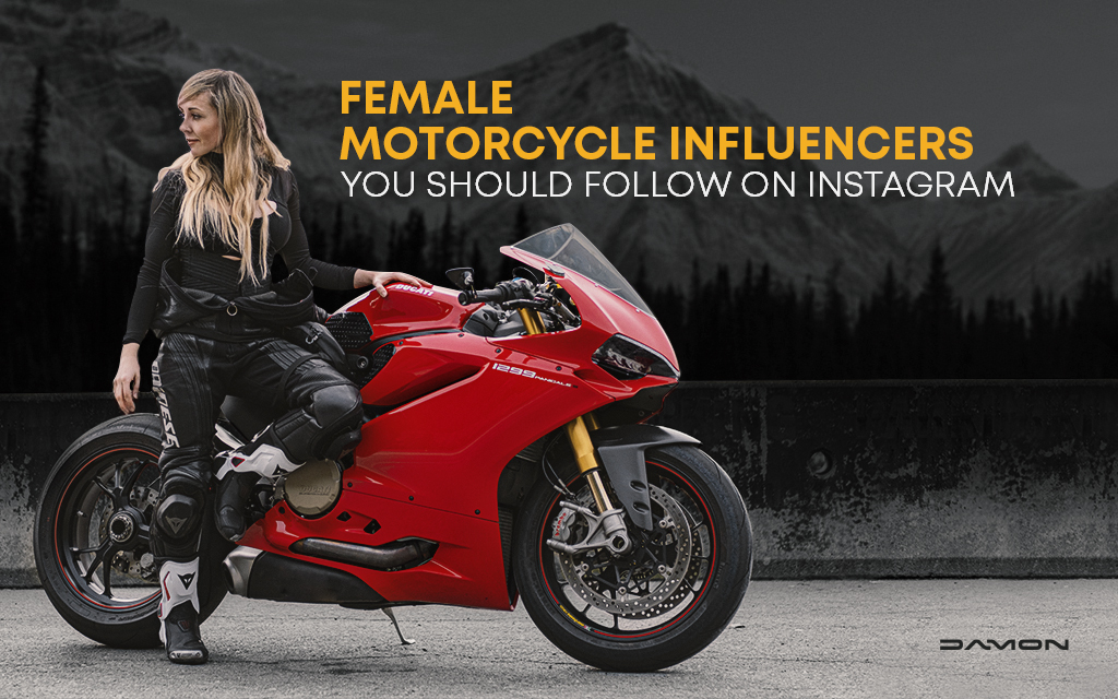 Blonde woman standing next to a red sportbike